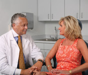 Woman talking with Male Doctor about Breast Augmentation